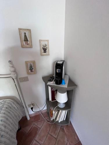 a corner of a room with a table with a printer at Tenuta Poggio alla Farnia in Fauglia