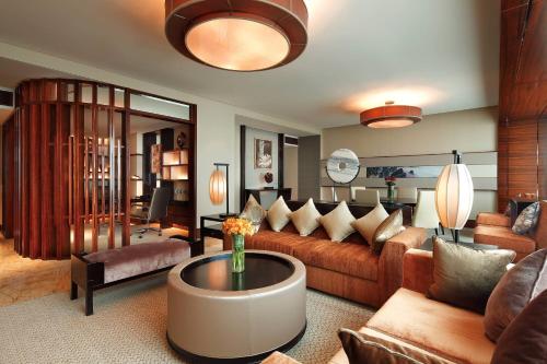 a living room with a couch and a table at Sheraton Hefei Xinzhan Hotel in Hefei