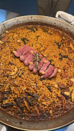 a pan full of food with meat and vegetables at DON LEONE Hotel in Alginet