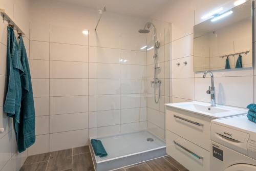 a bathroom with a shower and a sink at Sun Valley Apartments in Maishofen