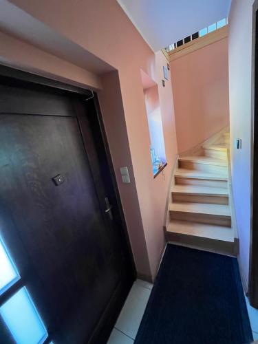 a staircase leading up to a door in a house at Apartament nad Zatoką Pucką in Swarzewo