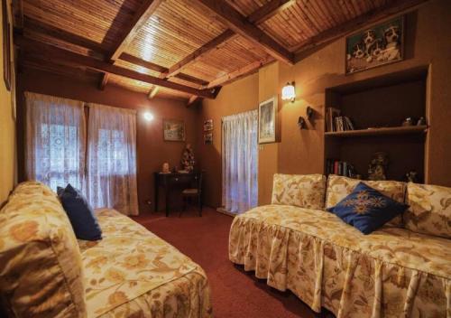 a living room with two beds and a couch at Ca d'Moreno in Viù