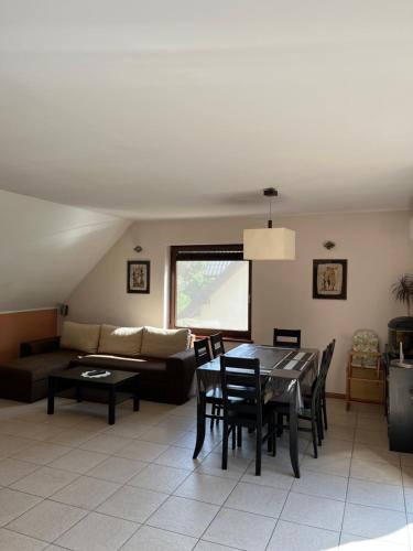 a living room with a table and a couch at Apartament nad Zatoką Pucką in Swarzewo