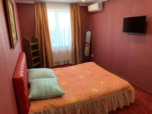 a small bedroom with a bed and a television at APARTMENT PREMIUM VIP in Berdychiv