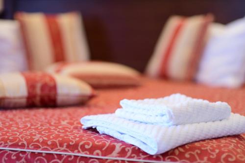 a pair of white towels sitting on a table at Hotel Imperial Premium in Timişoara