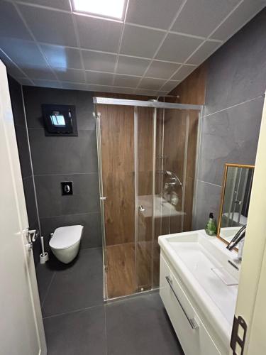 a bathroom with a shower and a toilet and a sink at 3 min to beach, luxury building in Antalya