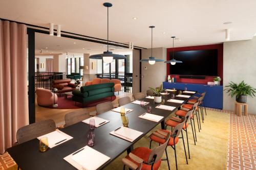 a conference room with a long table and chairs at Hotel Indigo Adelaide Markets by IHG in Adelaide