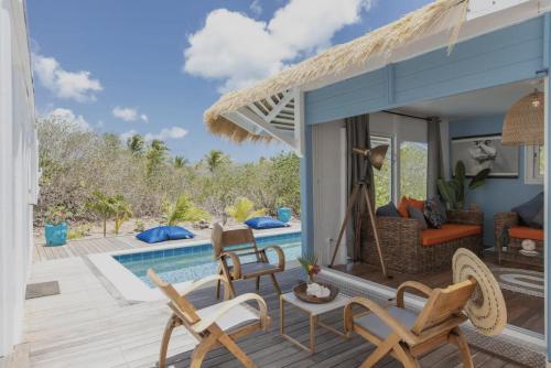 a villa with a swimming pool and a patio at Villa Branca - Les Terres Basses in Marigot