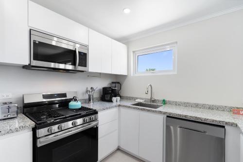 a kitchen with white cabinets and a black stove top oven at Summerside 5 in Palm-Eagle Beach