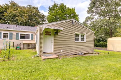 a house with a green door in a yard at Coventry Lake Getaway with Yard Near UConn! in Coventry