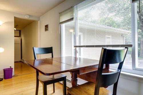 a dining room with a wooden table and two chairs at Coventry Lake Getaway with Yard Near UConn! in Coventry