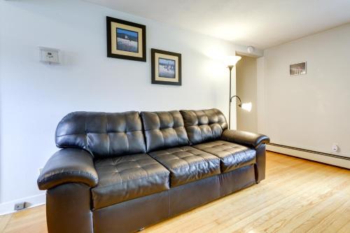 a leather couch sitting in a living room at Coventry Lake Getaway with Yard Near UConn! in Coventry