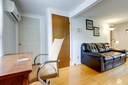 a living room with a leather couch and a table at Coventry Lake Getaway with Yard Near UConn! in Coventry