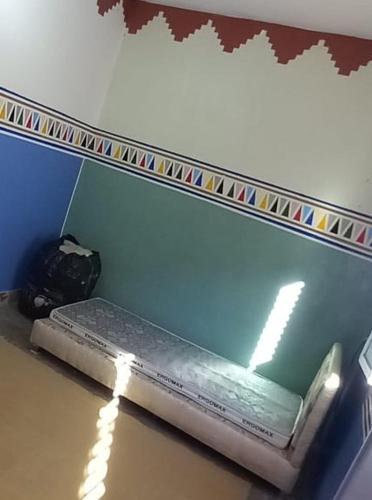 a bench in a room with a mirror at Hostel Yahdih Dakhla in Dakhla