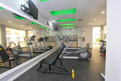 a gym with treadmills and elliptical machines at Holiday Inn Leon by IHG in León