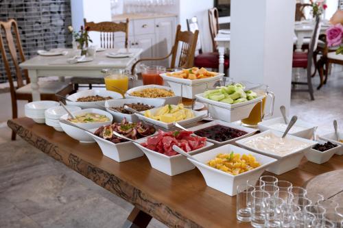 a buffet of food on a wooden table at Oude Werf Hotel in Stellenbosch