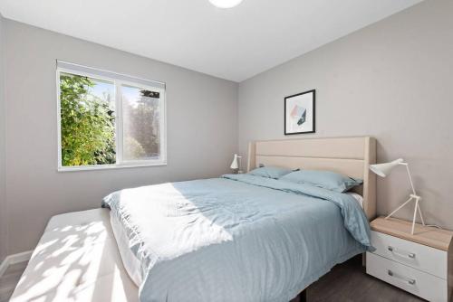 a bedroom with a large bed and a window at Cheerful Kirkland Home w&AC Big Yard,Walk to Beach in Kirkland