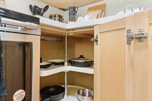 a small kitchen with some pots and pans at Cheerful Kirkland Home w&AC Big Yard,Walk to Beach in Kirkland