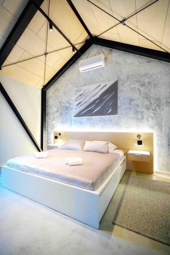 a bedroom with a large bed in a room at Magdala Lodge - wellness oasis in Donja Pušća