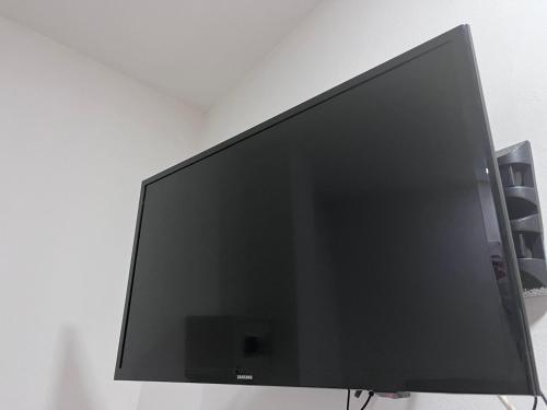 a large flat screen tv sitting on a wall at Hotel SGH Boutique Deluxe in Santa Marta
