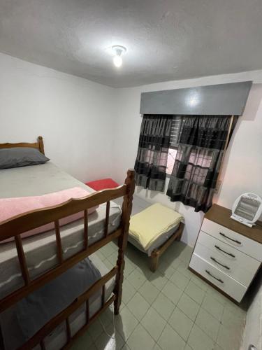 a bedroom with two bunk beds and a desk at MARVIR en Alvorada in Barra del Chuy