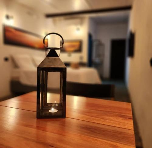 a lantern sitting on top of a wooden table at Suítes Domo do Matto in Garanhuns