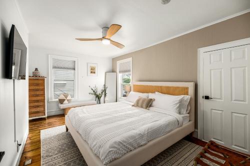a bedroom with a bed and a ceiling fan at A by the Bay - Stunning Seaside Apartment in Gloucester
