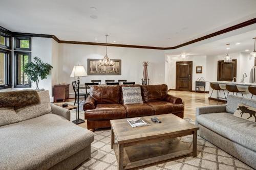 a living room with two couches and a table at Comfort at Arrowhead Village - Steps from the lift condo in Edwards