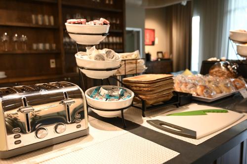 a counter with a toaster and other items on it at Art House Hotel in Santa Rosa