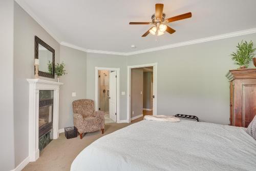 a bedroom with a bed and a ceiling fan and a fireplace at Luxe Midway Condo with Golf Course and Mountain Views! in Midway