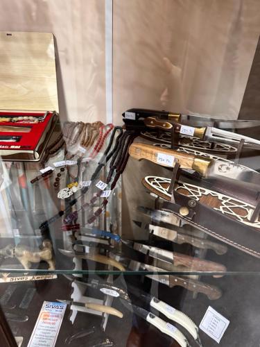 a glass display case with many weapons on display at Özkaya hotel in Sivas