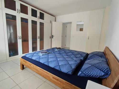 a bedroom with a bed with a blue and white comforter at 16 Sunset view in Adeje