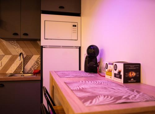 a bed in a kitchen with a box on it at La Suite Sun Set in Tremblay-En-France