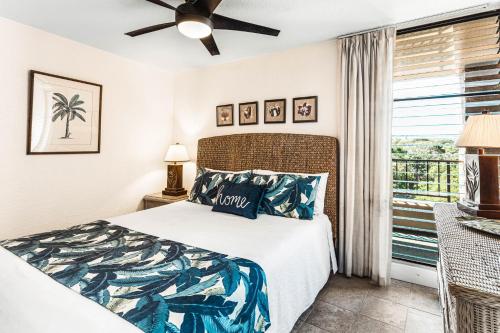 a bedroom with a bed and a window at Paki Maui 414 in Kahana
