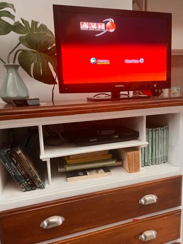 a tv sitting on top of a entertainment center at Monoambiente Manzanares in Cipolletti