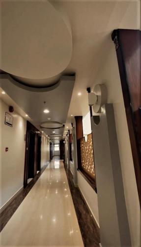 a long hallway in a building with a ceiling at Levant Hotel فندق قصر المشرق in Najran