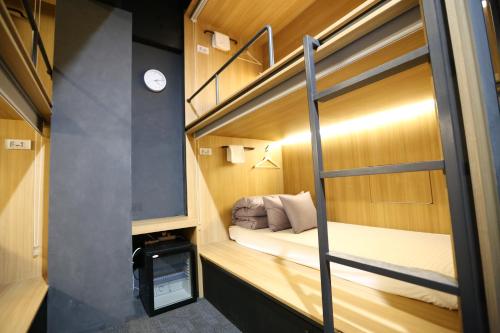 a small room with a bunk bed and a tv at Philstay Ehwa Boutique - Female Only in Seoul