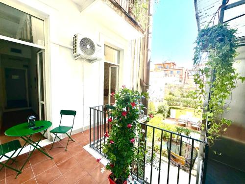 a balcony with a table and a plant at Trevi Romantic Alcova in Rome