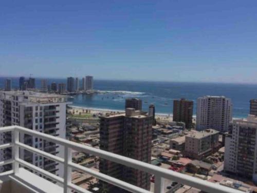 a view of the ocean from a balcony of a city at Bello depto a pasos de cavancha in Iquique