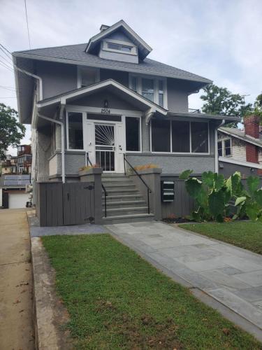 a gray house with a porch and a driveway at STS - Single Traveler Studio -Black Door in Washington