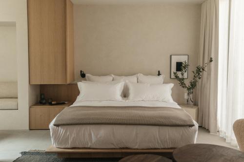 a bedroom with a large bed with white pillows at Octavia Casa in Mexico City