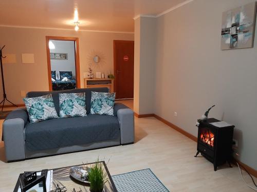 a living room with a couch and a fire place at Norverde - Açores in Nordestinho