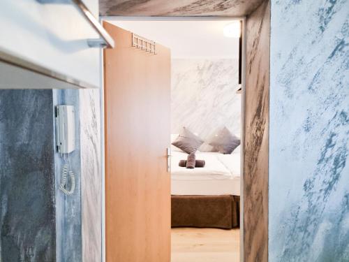 a room with a bed and a mirror at Da Vinci Apartment in Kapfenberg
