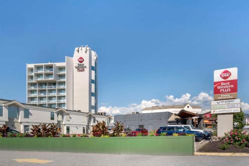 a parking lot with a hotel in the background at Best Western Plus Kelowna Hotel & Suites in Kelowna