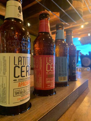a row of bottles of beer sitting on a shelf at Hotel Nantu Hostería in Puerto López