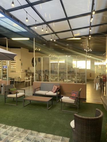 a lobby with couches and chairs and tables at Los Andes Bed & Breakfast in Arequipa