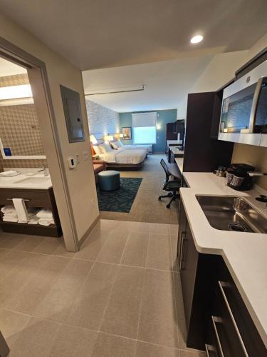eine Küche und ein Wohnzimmer mit einem Bett in einem Zimmer in der Unterkunft Home2 Suites By Hilton Allentown Bethlehem Airport in Bethlehem