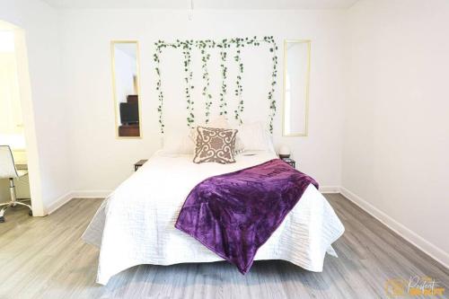 a bedroom with a large bed with purple sheets at Your home away from home! in Jackson