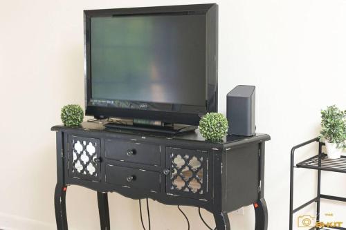 a black entertainment center with a television on top of it at Your home away from home! in Jackson