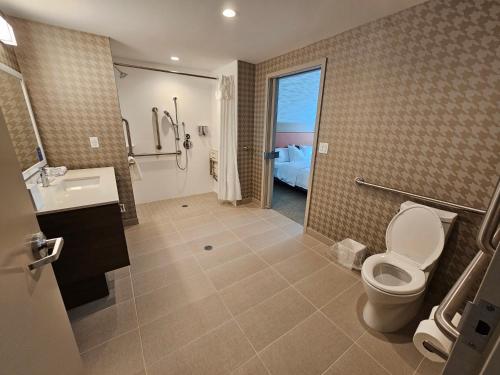 a bathroom with a toilet and a sink and a shower at Home2 Suites By Hilton Allentown Bethlehem Airport in Bethlehem